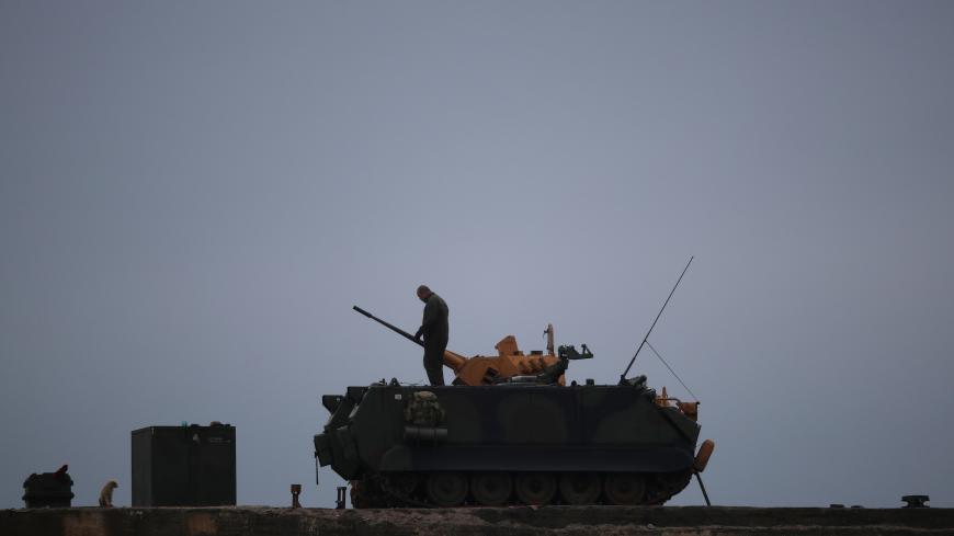 A Turkish soldier stands on an armoured vehicle in a village near the Turkish-Syrian border in Hatay province, Turkey February 25, 2018. REUTERS/Umit Bektas - RC174F023F10