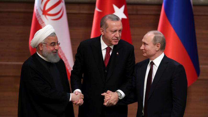 Presidents Hassan Rouhani of Iran, Tayyip Erdogan of Turkey and Vladimir Putin of Russia hold a joint news conference after their meeting in Ankara, Turkey April 4, 2018. REUTERS/Umit Bektas - RC17DDDED670