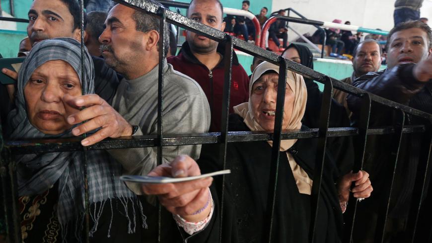 People wait to travel into Egypt, after the Rafah border crossing was opened for three days for humanitarian cases, in the southern Gaza Strip April 13, 2018. REUTERS/Ibraheem Abu Mustafa - RC13FB0C8DD0