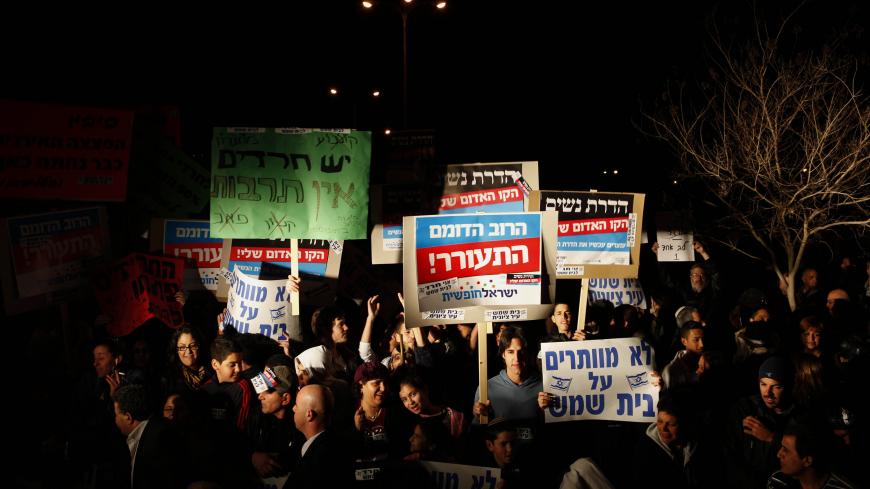 Israelis protest against gender segregation and violence towards women by ultra Orthodox Jewish extremists on December 27, 2011 in the town of Beit Shemesh, near Jerusalem. The protest comes after a wave of incidents in Israel in which women have been compelled to sit at the back of segregated buses serving ultra-Orthodox areas or get off, despite court rulings that women may sit where they please. AFP PHOTO/GALI TIBBON (Photo credit should read GALI TIBBON/AFP/Getty Images)