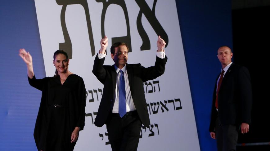 Co-leader of the Zionist Union party, Israeli Labour Party leader Isaac Herzog (C), arrives on stage with his wife Michal as he reacts to exit poll figures in Israel's parliamentary elections late on March 17, 2015 in the city of Tel Aviv. Israeli Prime Minister Benjamin Netanyahu's rightwing Likud party is neck-and-neck with the centre-left Zionist Union, exit polls say. AFP PHOTO / GALI TIBBON        (Photo credit should read GALI TIBBON/AFP/Getty Images)