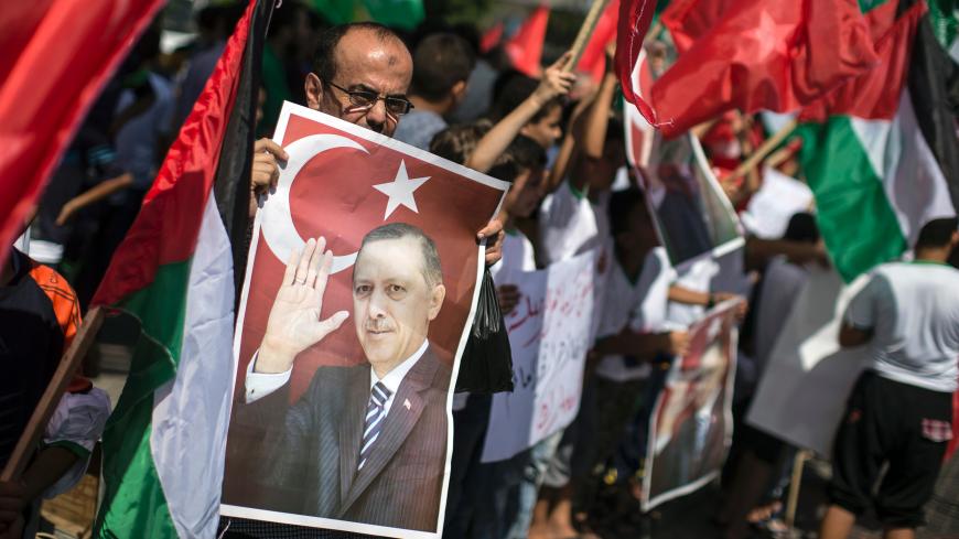 Palestinian supporters of the Hamas movement hold portraits of Turkish President Recep Tayyip Erdogan as they shout slogans against the military coup attempt in Turkey, during a demonstration in Gaza City, on July 16, 2016.
Erdogan battled to regain control over Turkey on July 16, 2016 after a coup bid by discontented soldiers, as signs grew that the most serious challenge to his 13 years of dominant rule was faltering. After a night of drama and bloodshed, at least 90 people had died and more than 1,150 pe