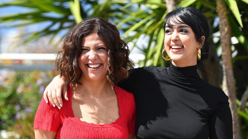 Tunisian director Kaouther Ben Hania (L) and Tunisian actress Mariam Al Ferjani pose on May 19, 2017 during a photocall for the film 'Beauty and the Dogs' (Aala Kaf Ifrit) at the 70th edition of the Cannes Film Festival in Cannes, southern France.  / AFP PHOTO / Alberto PIZZOLI        (Photo credit should read ALBERTO PIZZOLI/AFP/Getty Images)