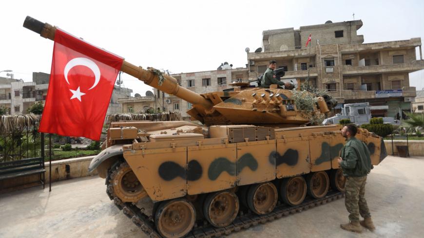 A tank belonging to Turkish soldiers and Ankara-backed Syrian Arab fighters is seen in the Kurdish-majority city of Afrin in northwestern Syria after they took control of it from Kurdish People's Protection Units (YPG) on March 18, 2018.
Turkish-backed rebels have seized the centre of Afrin city in northern Syria, Ankara said, as they made rapid gains in their campaign against Kurdish forces. A civilian inside Afrin said that rebels had deployed in the city centre and that the Kurdish People's Protection Un