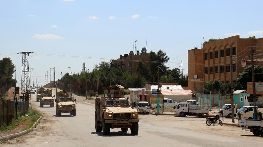 Vehicles of the US-led coalition battling the Islamic State group patrol the town of Rmelane in Syria's Hasakeh province on June 5, 2018. - The leading Syrian Kurdish militia said it would withdraw from Manbij, easing fears of a direct clash between NATO allies Washington and Ankara over the strategic northern town. Manbij is a Sunni Arab-majority town that lies just 30 kilometres (19 miles) south of the Turkish border, and where US and French troops belonging to the Western coalition against IS are station