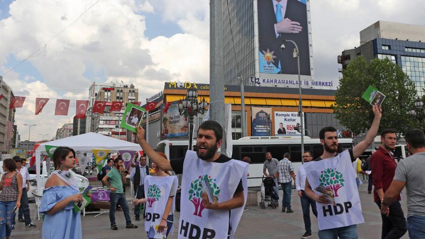 Supporters of pro-Kurdish Peoples' Democratic Party (HDP) distribute brochures on June 7, 2018 in Ankara, ahead of the Turkish presidential elections. (Photo by ADEM ALTAN / AFP)        (Photo credit should read ADEM ALTAN/AFP/Getty Images)