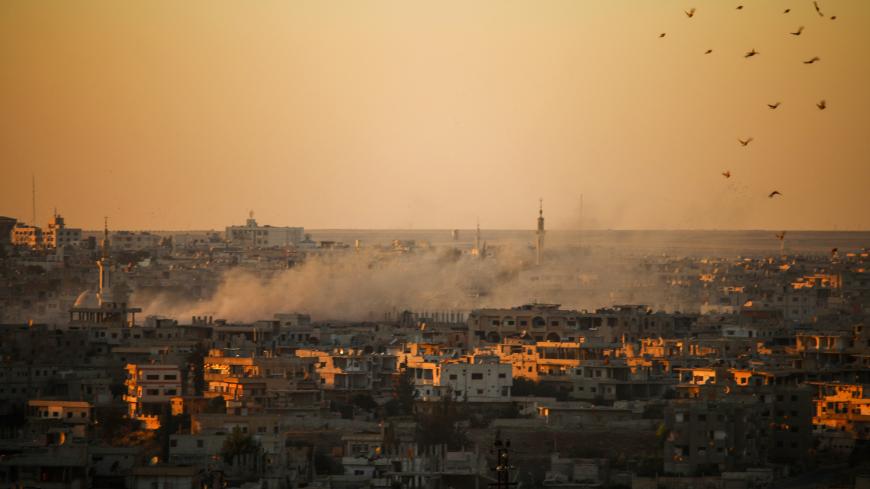 Smoke rises above opposition held areas of Daraa during airstrikes by Syrian regime forces on June 26, 2018. - Russian-backed regime forces have for weeks been preparing an offensive to retake Syria's south, a strategic zone that borders both Jordan and the Israeli-occupied Golan Heights. (Photo by Mohamad ABAZEED / AFP)        (Photo credit should read MOHAMAD ABAZEED/AFP/Getty Images)