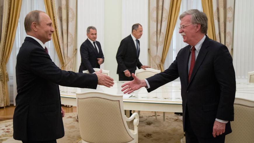 Russia's President Vladimir Putin (L) shakes hands with U.S. National Security Adviser John Bolton during a meeting at the Kremlin in Moscow, Russia June 27, 2018. Alexander Zemlianichenko/Pool via REUTERS - RC1B77CFA910