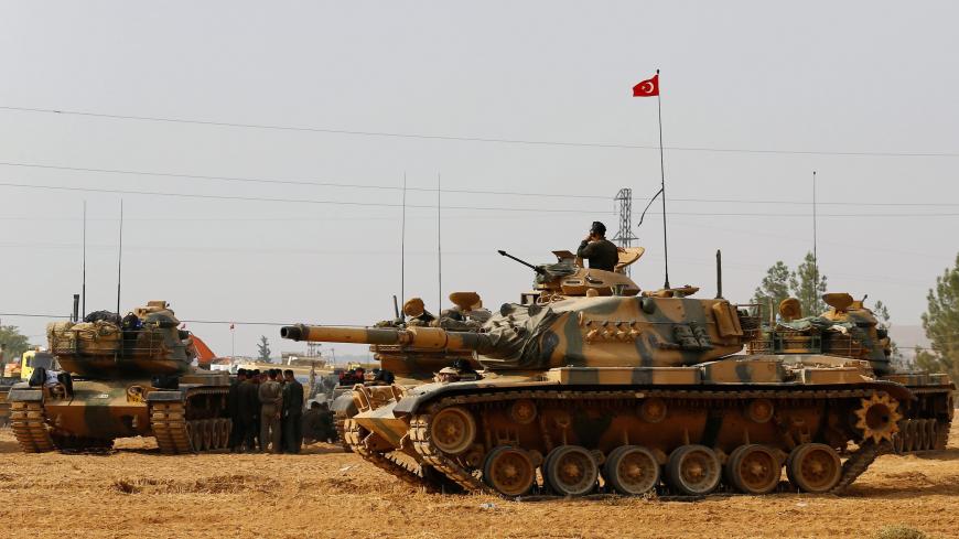 Turkish army tanks and military personal are stationed in Karkamis on the Turkish-Syrian border in the southeastern Gaziantep province, Turkey, August 25, 2016. REUTERS/Umit Bektas/File Photo - S1BEUGNIHMAA