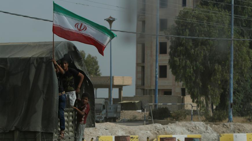 Iranian flag flutters on a truck carrying humanitarian aid in Deir al-Zor, Syria September 20, 2017. Picture taken September 20, 2017. REUTERS/Omar Sanadiki - RC1AFCE7F550