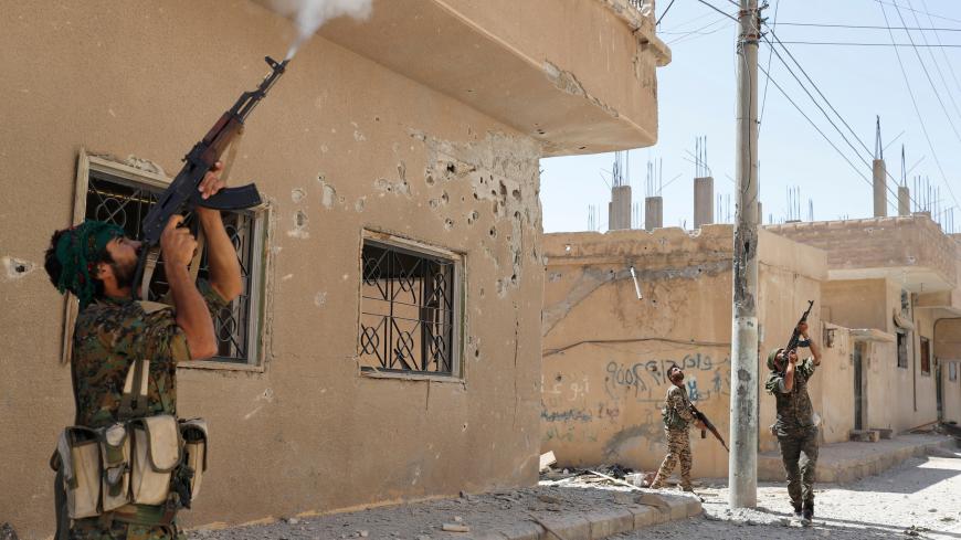 Kurdish fighters from the People's Protection Units (YPG) fire rifles at a drone operated by Islamic State militants in Raqqa, Syria, June 16, 2017. Goran Tomasevic: "ISIS uses drones to monitor Kurdish fighters and drop bombs at their positions. On a few occasions I ran into a house with fighters because of drones. On one occasion a bomb from a drone landed near a house where I was hiding with the rest of our team and YPG fighters. The biggest challenge in Raqqa was very limited access and the heat. The te