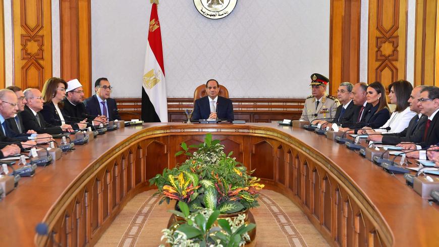 Egyptian President Abdel Fattah al-Sisi (C) and Mustafa Madbouly (6th L), newly appointed Prime Minister attend the first meeting after Egypt appointed a new government on Thursday at the Ittihadiya presidential palace in Cairo, Egypt, June 14, 2018, in this handout picture courtesy of the Egyptian Presidency. The Egyptian Presidency/Handout via REUTERS ATTENTION EDITORS - THIS IMAGE WAS PROVIDED BY A THIRD PARTY - RC118173BD60