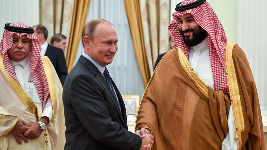 Russian President Vladimir Putin shakes hands with Saudi Crown Prince Mohammed bin Salman during their meeting at the Kremlin in Moscow, Russia June 14, 2018. Yuri Kadobnov/Pool via REUTERS - RC1F6D500190