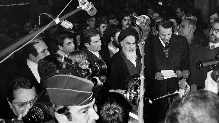 Iranian opposition leader in exile ayatollah Ruhollah Khomeiny gives a speech as journalists surround him at Roissy airport near Paris on January 31, 1979 before boarding an Air France "Jumbo Jet" bound to Tehran. Although Iran's US-backed shah had already fled the country when Khomeini returned from exile in the small French town of Neauphle-le-Chateau, the 747's landing is seen as the true start of the Islamic revolution. AFP PHOTO MARCEL BINH (Photo credit should read MARCEL BINH/AFP/Getty Images)