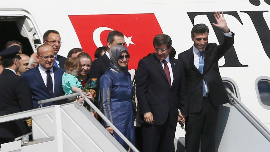 Turkeys Prime Minister Ahmet Davutoglu (C) and his wife Sare Davutoglu (L), welcome freed Turkey's Consul in Mosul Ozturk Yilmaz (R) and dozens of other freed Turkish nationals hostages held by Islamist militants in northern Iraq for more than three months, on September 20, 2014 at the Esenboga Airport in Ankara. Fighters from the Islamic State (IS) kidnapped 46 Turks including diplomats, children and special forces from the Turkish consulate in Mosul and 3 Iraqis on June 11 as they captured swathes of nort