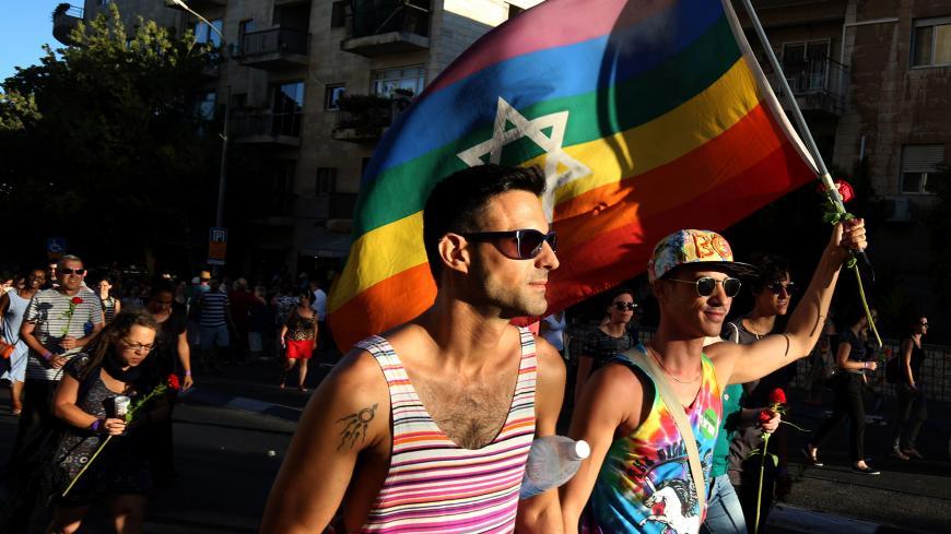 Israelis carry a gay pride rainbow flag with the Star of David during the annual Jerusalem Gay Pride Parade on July 21, 2016.
Israeli police said they suspected the man behind the attack on last year's march, Yishai Shlissel, an ultra-Orthodox Jew who killed a teenager and stabbed five other people, had been in contact with his brother from prison about an assault on the event. / AFP / GALI TIBBON        (Photo credit should read GALI TIBBON/AFP/Getty Images)