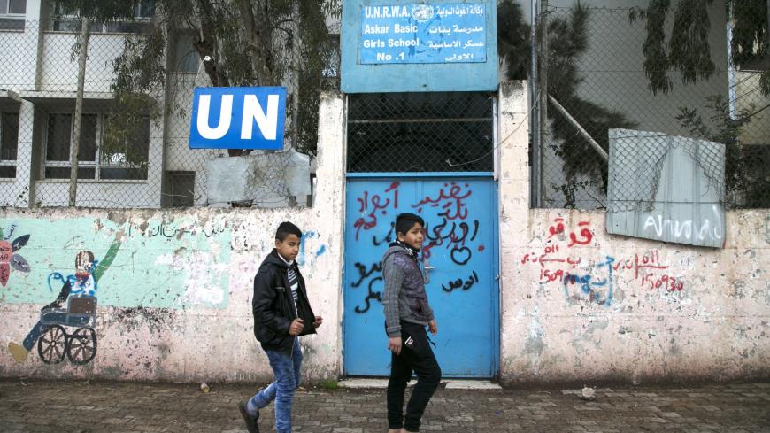 Palestinian children walk outside of the United Nations' school in the Askar refugee camp, near Nablus in the Israeli occupied West Bank, on January 17, 2018 after the White House froze tens of millions of dollars in contributions. - The agency provides Palestinian refugees and their descendants across the Middle East with services including schools and medical care, but Prime Minister Benjamin Netanyahu has long accused it of hostility toward Israel and called for its closure. (Photo by JAAFAR ASHTIYEH / A