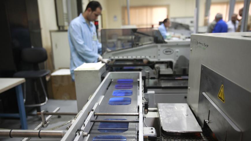 An employee is seen on the production line of the solar energy department at the Arab International Optronics (AIO) factory on the outskirts of Cairo, November 17,  2011. Picture taken November 17,  2011.     REUTERS/Asmaa Waguih (EGYPT  - Tags: MILITARY ENERGY POLITICS)   - LR2E84410PK0W