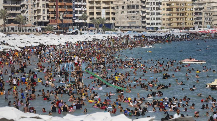 Egyptians crowd a public beach during a hot day in the Mediterranean city of Alexandria September 5, 2014. El Max, in Alexandria, where hundreds of boats dart through the canals, has been called the "Venice of Egypt" for its waterways and relaxed atmosphere. Its fishermen, however, worry about how they will make ends meet on meagre earnings they say are being reduced further by polluted waters that are making fishing more difficult. While the government has tried to fix the state's bloated finances by cutti