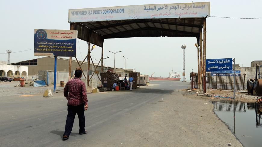 A man walks towards the gate of the Red Sea port of Hodeidah, Yemen June 24, 2018. REUTERS/Abduljabbar Zeyad - RC1869894F80