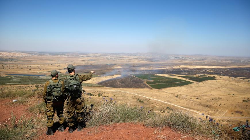 Israeli soldiers look at the Syrian side of the Israel-Syria border on the Israeli-occupied Golan Heights, Israel July 7, 2018. REUTERS/Ronen Zvulun - RC18A49EEEF0