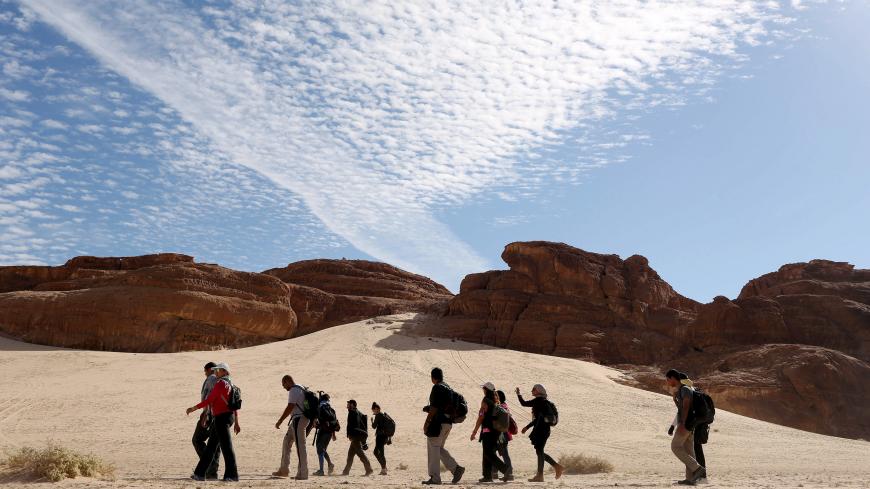 Hikers walk in the Wadi Hudra area in South Sinai, Egypt, November 21, 2015. Bedouins in the "Sinai is Safe" group guided more than 100 hikers over a 25 km (15 mile) trek over the trails of the White Canyon and the Closed Canyon. The NGO aims to challenge mainstream perceptions of the area by encouraging Nile Valley residents to explore the untamed wilderness with the Bedouin tribes. Picture taken November 21, 2015. REUTERS/Asmaa Waguih   - GF20000080091