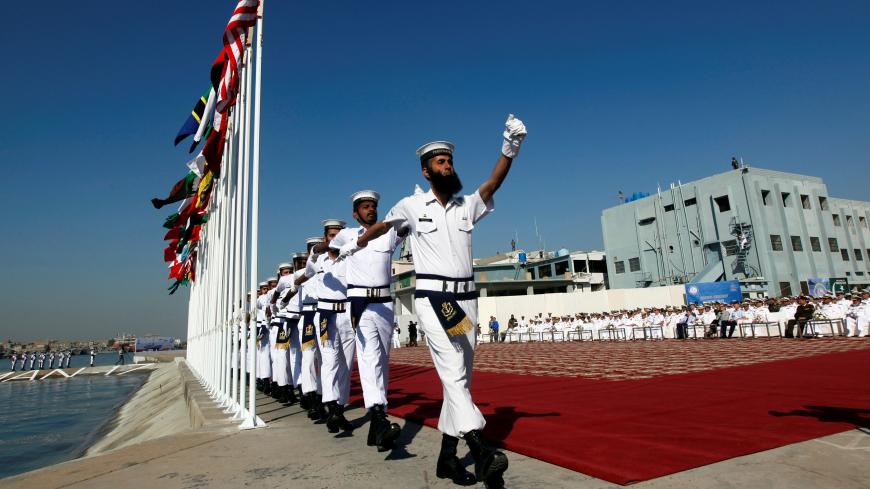 Pakistan Navy's servicemen march after hoisting the national flags of participating countries during the opening ceremony of Pakistan Navyís Multinational Exercise AMAN-17, in Karachi, Pakistan February 10, 2017. REUTERS/Akhtar Soomro - RC11ADB28990