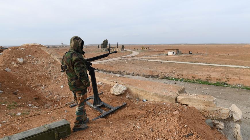 A Syrian Army soldier loyal to Syria's President Bashar al-Assad forces stands next to a military weapon in Idlib, Syria January 21, 2018. Picture taken January 21, 2018. SANA/Handout via REUTERS ATTENTION EDITORS - THIS PICTURE WAS PROVIDED BY A THIRD PARTY. REUTERS IS UNABLE TO INDEPENDENTLY VERIFY THE AUTHENTICITY, CONTENT, LOCATION OR DATE OF THIS IMAGE. - RC19C0D8B740