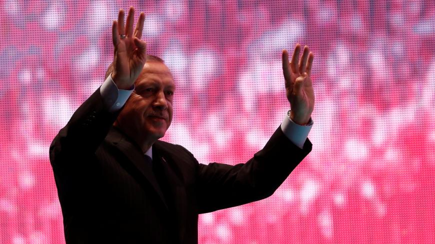 Turkish President Tayyip Erdogan greets his supporters during a ceremony marking the second anniversary of the attempted coup at the Bosphorus Bridge in Istanbul, Turkey, July 15, 2018. REUTERS/Murad Sezer - RC16BA573790