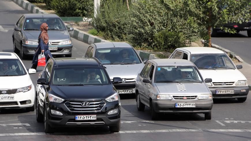 TO GO WITH AFP STORY BY ALI NOORANI - A picture taken on September 12, 2015 shows Iranians driving a Pride car manufactured by SAIPA group (R) and a Hyundai ix45 luxury car (L) in northern Tehran. A campaign to boycott "substandard and expensive" Iranian-made cars has fired up social media in the Islamic republic, where its supporters have been accused of anti-revolutionary treason.   AFP PHOTO / ATTA KENARE        (Photo credit should read ATTA KENARE/AFP/Getty Images)