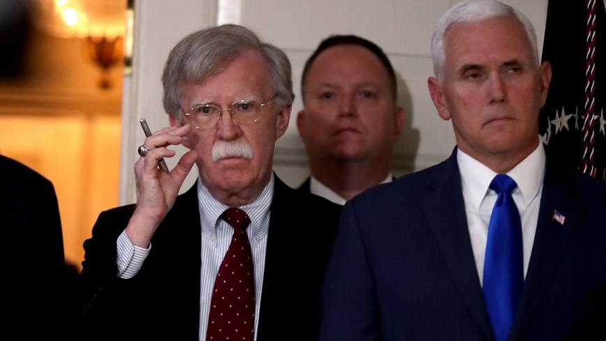 WASHINGTON, DC - MAY 08:  White House National Security Advisor John Bolton (L) and Vice President Mike Pence listen to President Donald Trump announce his decision to withdraw the United States from the 2015 Iran nuclear deal in the Diplomatic Room at the White House May 8, 2018 in Washington, DC. After two and a half years of negotiations, Iran agreed in 2015 to end its nuclear program in exchange for Western countries, including the United States, lifting decades of economic sanctions. Since then interna