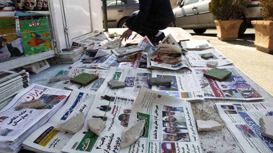 EDITORS' NOTE: Reuters and other foreign media are subject to Iranian restrictions on leaving the office to report, film or take pictures in Tehran.
A man looks at newspapers at a news stand in Tehran March 4, 2012. Hardliners allied with Iran's Supreme Leader Ayatollah Ali Khamenei maintained their lead in the country's parliamentary vote, with partial results on Sunday showing supporters of the president trailing behind. REUTERS/Raheb Homavandi  (IRAN - Tags: POLITICS ELECTIONS) - GM1E8341DST01