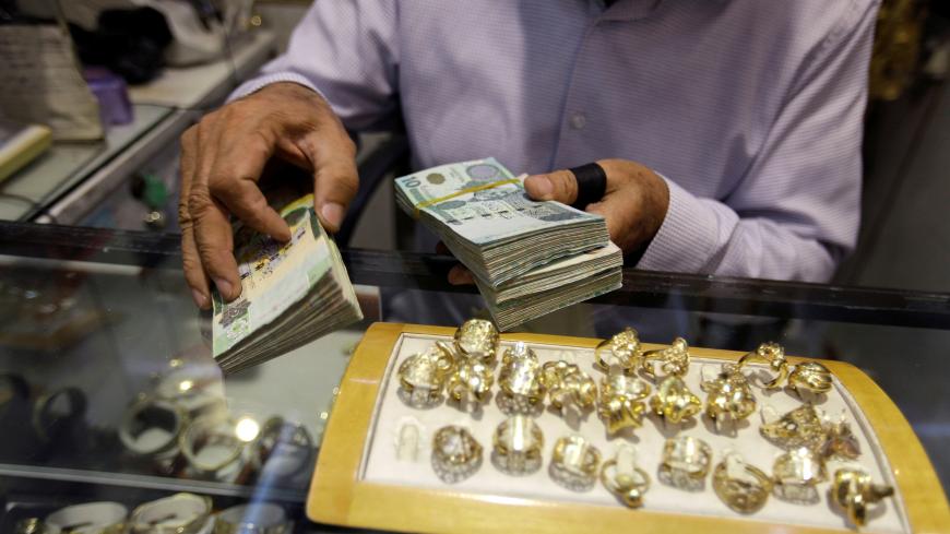 A man displays Libyan Dinar banknotes in a jewellery store in the old city of Tripoli, Libya October 26, 2017. Picture taken October 26, 2017. REUTERS/Ismail Zitouny - RC15E19B5990