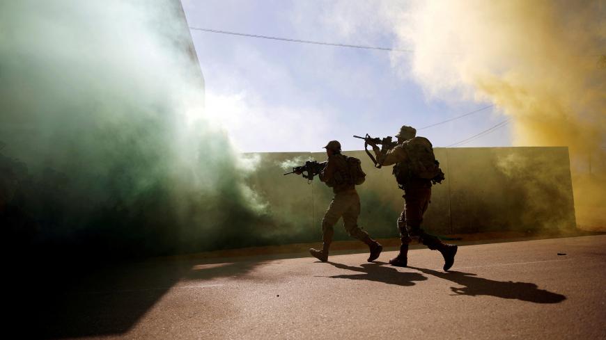 U.S. Marine and an Israeli soldier practice urban combat during Juniper Cobra, a U.S.-Israeli joint air defence exercise, in Zeelim, southern Israel, March 12, 2018. Picture taken March 12, 2018. REUTERS/Amir Cohen     TPX IMAGES OF THE DAY - RC1B52D889D0