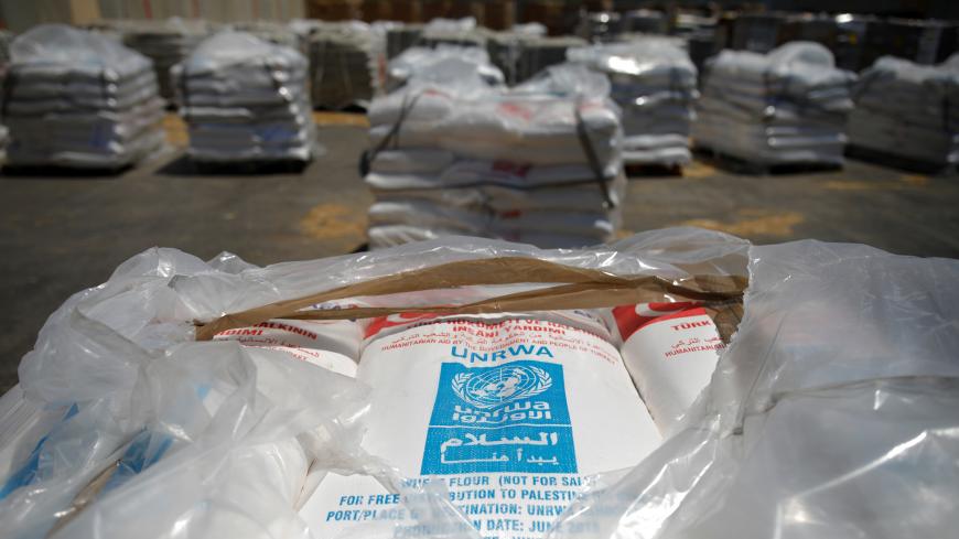 Bags containing aid from the U.N. Relief and Works Agency (UNRWA) are seen ahead of their transfer to the Gaza Strip, inside the Kerem Shalom border crossing terminal between Israel and Gaza Strip, Israel August 15, 2018. REUTERS/Amir Cohen - RC12571A1CB0