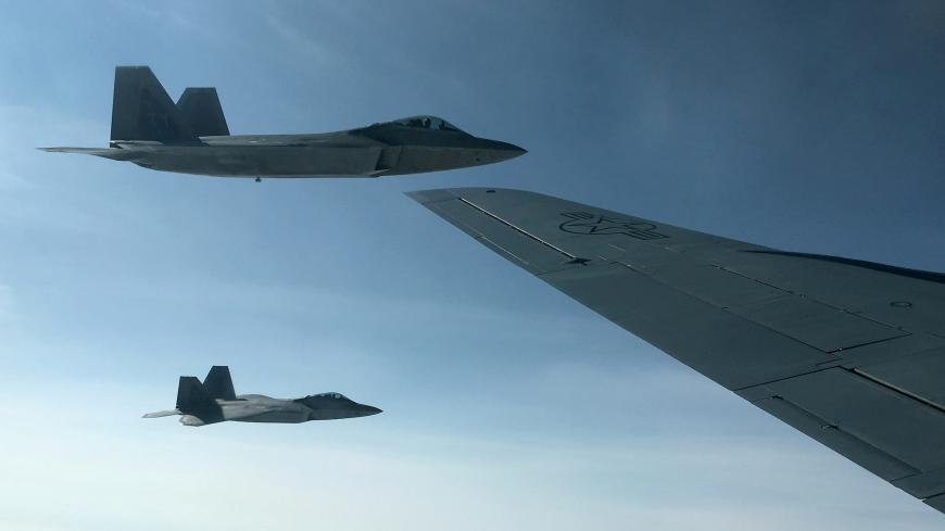 Two U.S. Air Force F-22 stealth fighter jets are about to receive fuel mid-air from a KC-135 refueling plane over Norway en route to a joint training exercise with Norway's growing fleet of F-35 jets August 15, 2018.  REUTERS/Andrea Shalal - RC1BFCD5DE40
