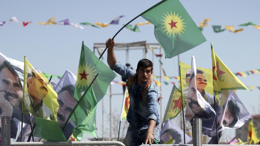A demonstrator waves a flag of the outlawed Kurdistan Workers Party (PKK) during a gathering to celebrate the spring festival of Newroz in the Kurdish-dominated southeastern city of Diyarbakir, Turkey March 21, 2016. Turkey's Kurds on Monday marked the annual spring festival of Newroz with a call for the resumption of peace talks between the government and Kurdish militants, but four Turkish soldiers were killed in another rebel attack in the restive southeast region. REUTERS/Sertac Kayar - GF10000354403
