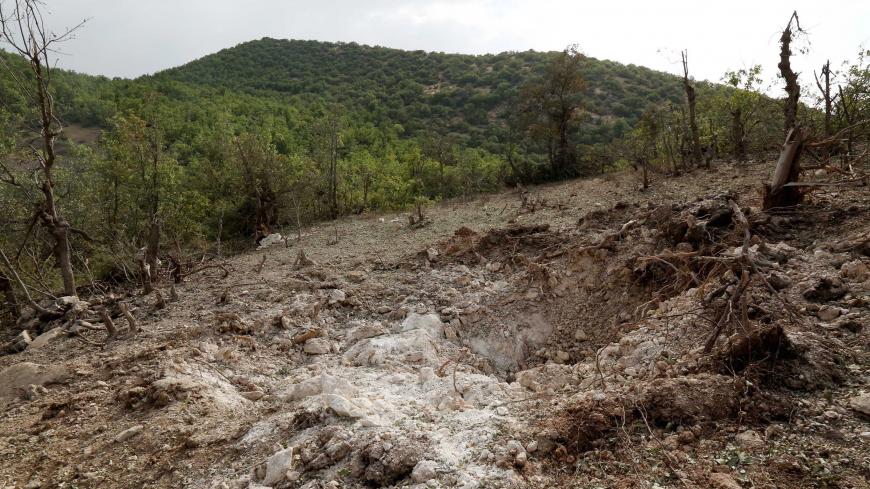 A crater caused by a Turkish air strike against Kurdistan Workers Party (PKK) camps in the village of Amadiya, outskirts of Dohuk province July 29, 2015. Turkish jets launched their heaviest assault on Kurdish militants in northern Iraq overnight since air strikes began last week, hours after President Tayyip Erdogan said a peace process had become impossible. REUTERS/Ari Jalal - GF20000008259