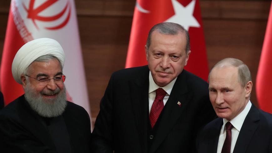 Presidents Hassan Rouhani of Iran, Tayyip Erdogan of Turkey and Vladimir Putin of Russia hold a joint news conference after their meeting in Ankara, Turkey April 4, 2018. REUTERS/Umit Bektas - RC1E49CD8120