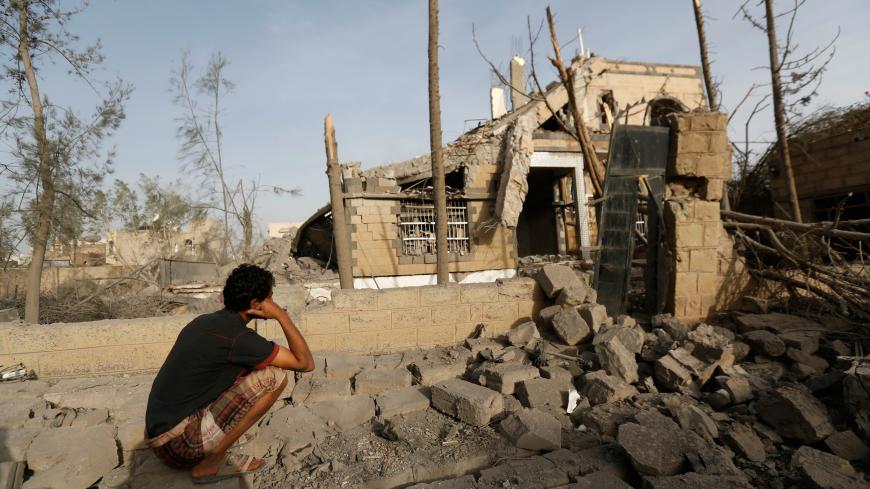 A man sits in front of a house destroyed by air strikes in Sanaa, Yemen June 6, 2018. REUTERS/Khaled Abdullah - RC1182083EA0