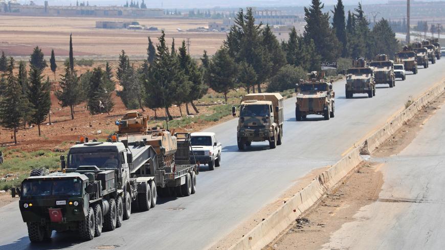 Turkish forces are seen in a convoy on a main highway between Damascus and Aleppo, near the town of Saraqib in Syria's northern Idlib province, on August 29, 2018. - Russian Foreign Minister Sergei Lavrov said in a press conference today that there is "full political understanding" between Russia and Turkey, who support opposing sides of the Syrian civil war but are currently in intense negotiations to ensure Idlib does not become a breaking point in their alliance. (Photo by OMAR HAJ KADOUR / AFP)        (
