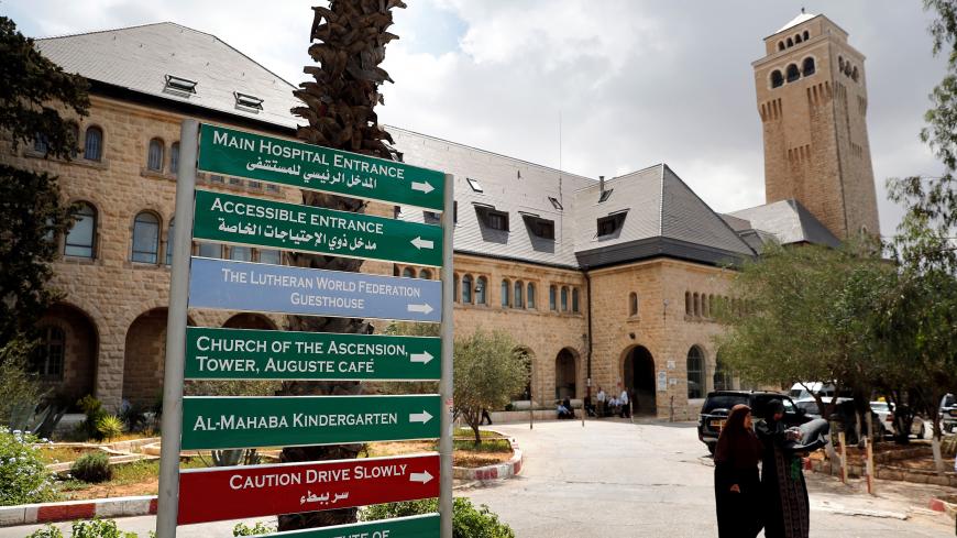 People walk outside of the Augusta Victoria hospital in East Jerusalem on September 9, 2018. - The United States plans to cut $25 million in aid to six hospitals primarily serving Palestinians in Jerusalem, a State Department official confirmed on September 8. The official said the decision followed a President Donald Trump-directed review of assistance to the Palestinian Authority and in the West Bank and Gaza "to ensure these funds were being spent in accordance with US national interests and were providi