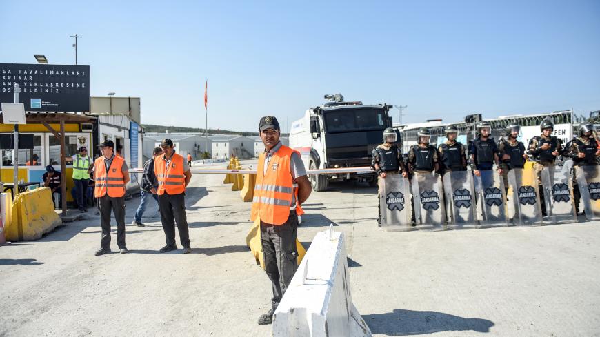 Security members and gendarmes are seen at the entrance of Istanbul new airport building site on September 15, 2018, in Istanbul. - Turkish police have detained hundreds of workers protesting over labour conditions at Istanbul's new airport, a giant project championed by President Tayyip Erdogan and due to open next month. (Photo by BULENT KILIC / AFP)        (Photo credit should read BULENT KILIC/AFP/Getty Images)