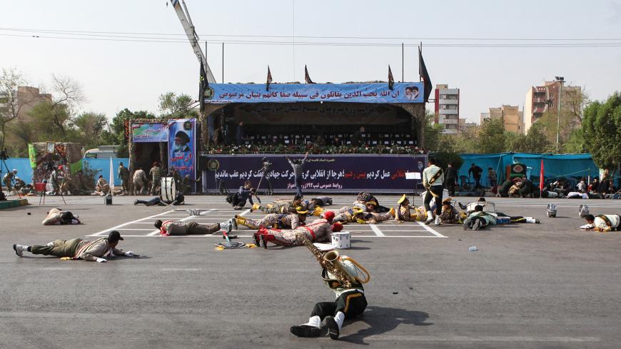 TOPSHOT - This picture taken on September 22, 2018 in the southwestern Iranian city of Ahvaz shows injured soldiers lying on the ground at the scene of an attack on a military parade that was marking the anniversary of the outbreak of its devastating 1980-1988 war with Saddam Hussein's Iraq. - Dozens of people were killed with dozens others wounded in an attack in the southwestern Khuzestan province on September 22 targeting on an army parade commemorating the anniversary of the 1980-1988 Iran Iraq war, sta