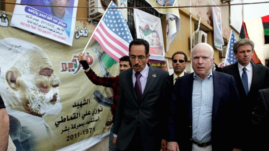 US Rebuplican senator John McCain (R) walks with Abdul Hafiz Ghoqa, spokesman of the Libyan National Transitional Council (NTC), during his tour to the rebel headquarters in their eastern stronghold city of Benghazi on April 22, 2011. McCain is the highest-ranking US politician to visit Libya's rebel-held east since a popular uprising began against Moamer Kadhafi's rule in mid-February. AFP PHOTO/MARWAN NAAMANI (Photo credit should read MARWAN NAAMANI/AFP/Getty Images)