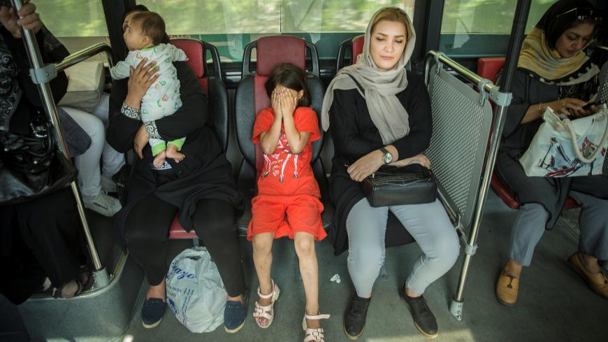 A girl and women ride on a bus in Tehran, Iran, August 2, 2017. Nazanin Tabatabaee Yazdi/TIMA via REUTERS ATTENTION EDITORS - THIS IMAGE WAS PROVIDED BY A THIRD PARTY. - RC1155A0F140