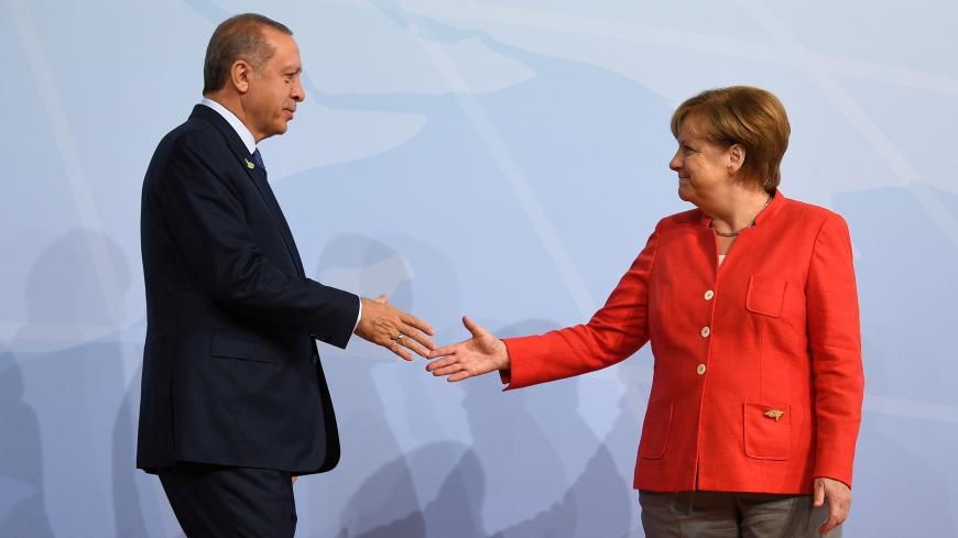 German Chancellor Angela Merkel greets Turkey's President Recep Tayyip Erdogan at the beginning of the G20 summit in Hamburg, Germany, July 7, 2017. REUTERS/Bernd Von Jutrczenka/POOL - RC16778A3FD0