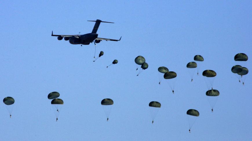 American and Egyptian paratroopers are air-dropped from a C-130 Hercules aircraft during exercise Bright Star 2007, at Kum Oshim 90 km (56 miles) south of Cairo, Egypt November 8, 2007. REUTERS/Nasser Nuri  (EGYPT ) - GM1DWNYROZAA