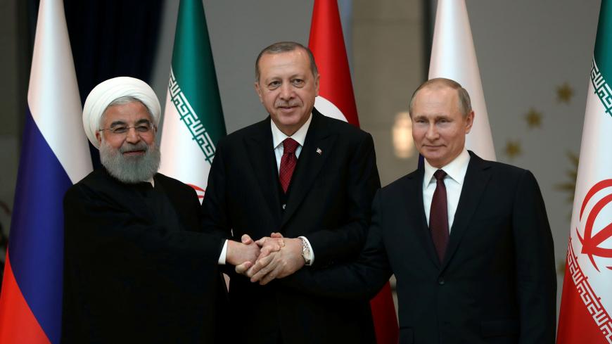 Presidents Hassan Rouhani of Iran, Tayyip Erdogan of Turkey and Vladimir Putin of Russia pose before their meeting in Ankara, Turkey April 4, 2018. Tolga Bozoglu/Pool via Reuters     TPX IMAGES OF THE DAY - RC1C3F373790