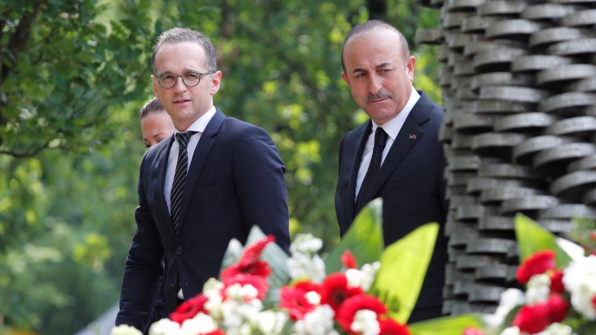Turkish Foreign Minister Mevlut Cavusoglu and his German counterpart Heiko Maas commemorate the 25th anniversary of an arson attack killing two Turkish women and three girls by right-wing extremists in Solingen, Germany, May 29, 2018. REUTERS/Wolfgang Rattay - RC1C23FA1490